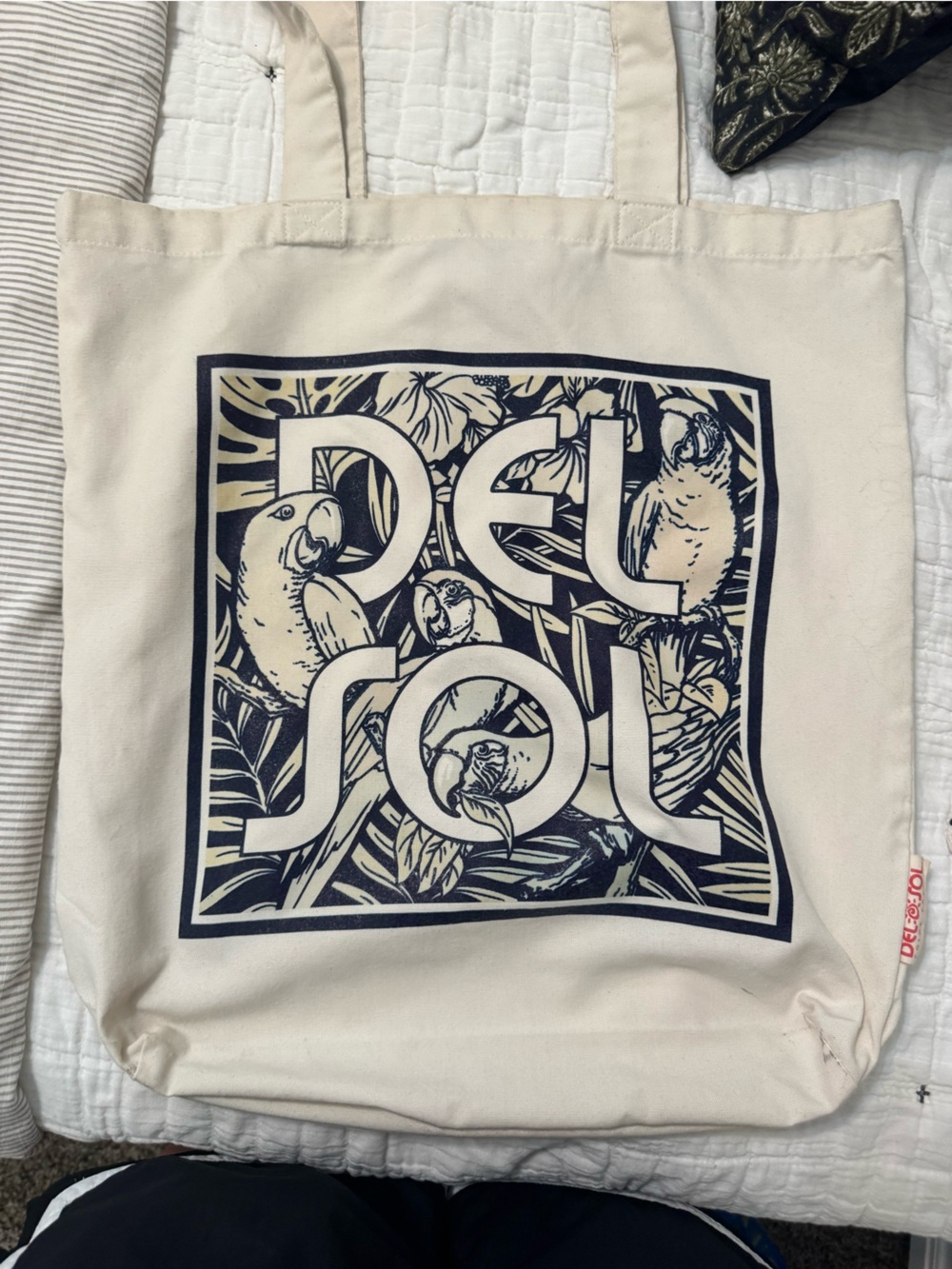 Del Sol color changing Cream Canvas Shoulder Tote with Navy Parrot Graphic